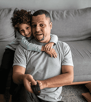Father and son watching television on the couch