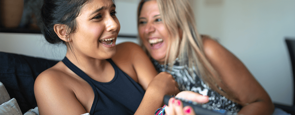 Mother and daughter watching television