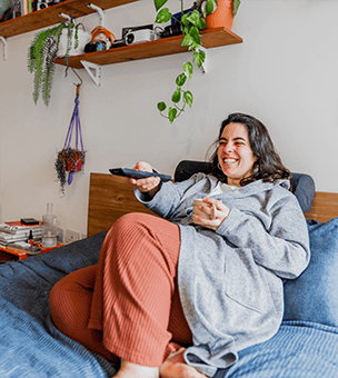 Woman watching TV in bed