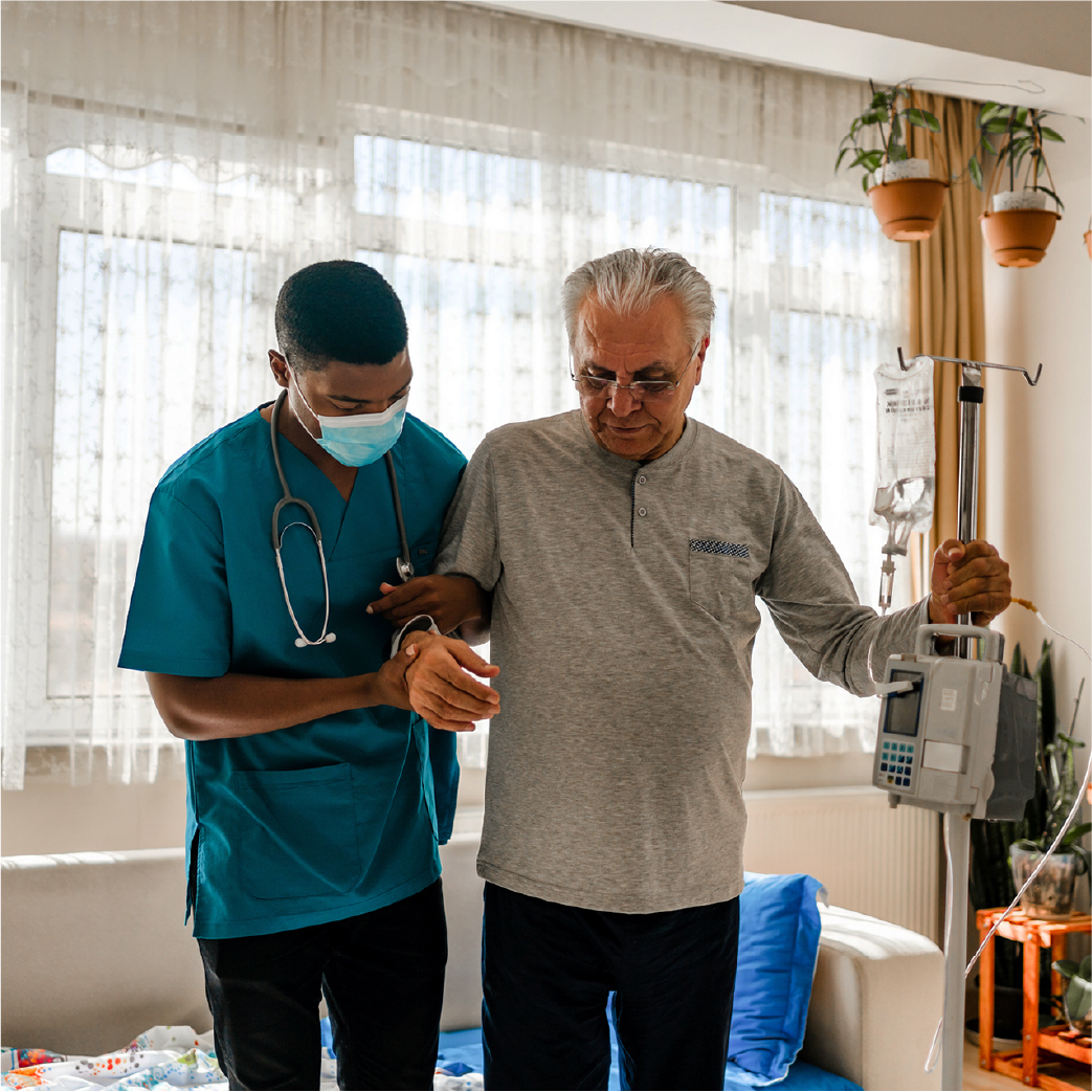 Caregiver assisting senior man