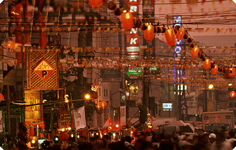 Multiple lamps lit in a busy street