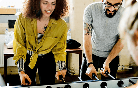 Two people playing Foosball