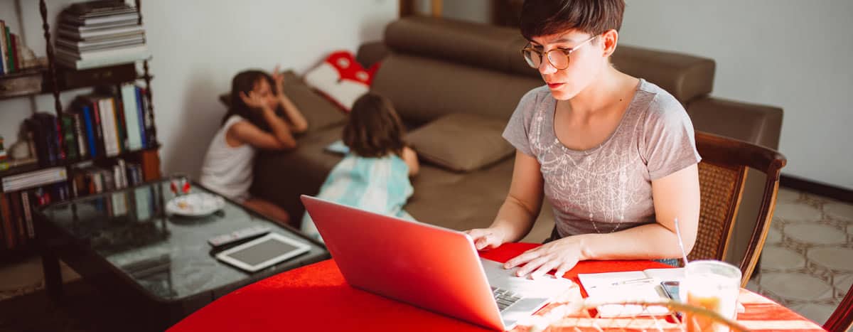 Women working from home with kids in background