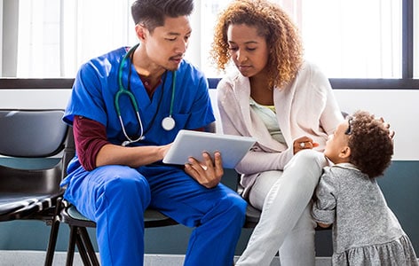 A patient and doctor along with a kid in a setup