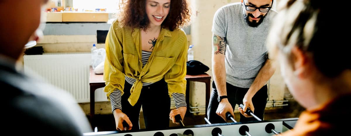 A group of people playing Foosball