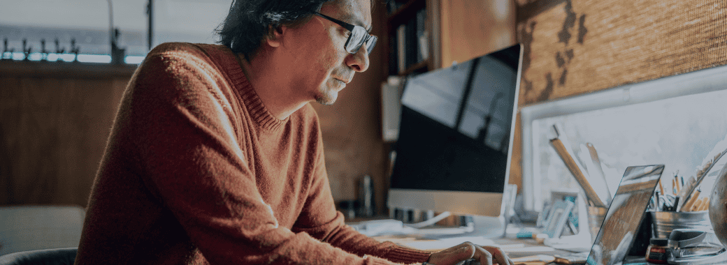 Man working on a computer at home