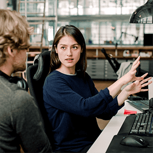 Woman explaining something to a coworker
