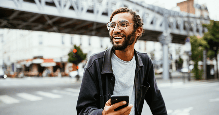 Millennial on phone in big city