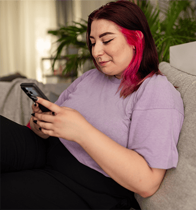 Young woman with pink hair on phone