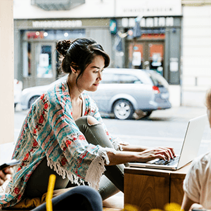 Woman working on laptop at a coffee shop