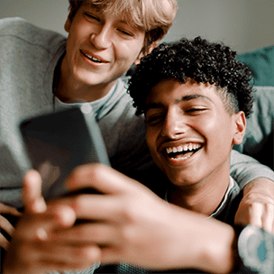 Two Gen Z men looking at a phone together