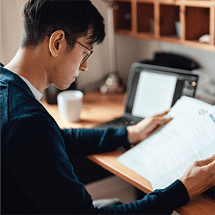 Man reviewing papers in home office