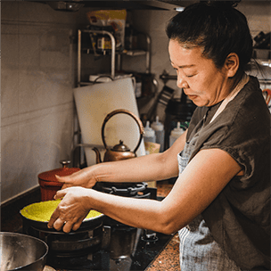 Woman cooking in professional kitchen