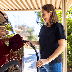 Woman filling her car up with gas