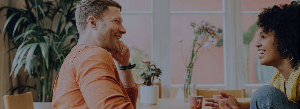 Man and woman out to coffee, happily chatting