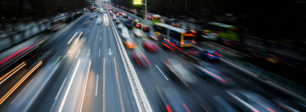 Fast cars going by on a city street at night