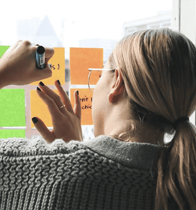 Woman writing on post-it notes