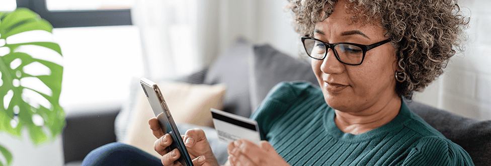 Woman paying by credit card on her phone