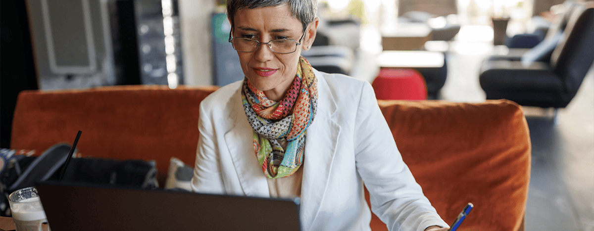 A lady working from a couch