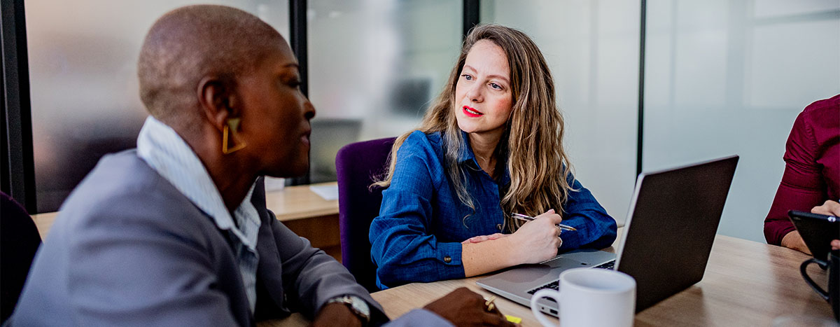 Two colleagues discussing in a meeting room