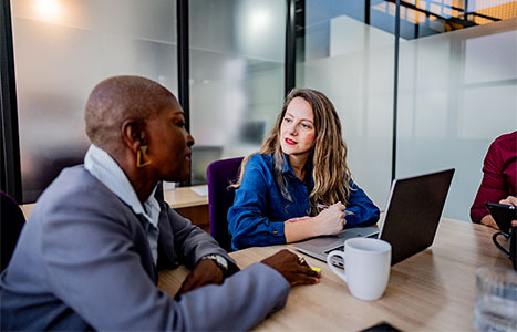 Two colleagues discussing in a meeting room