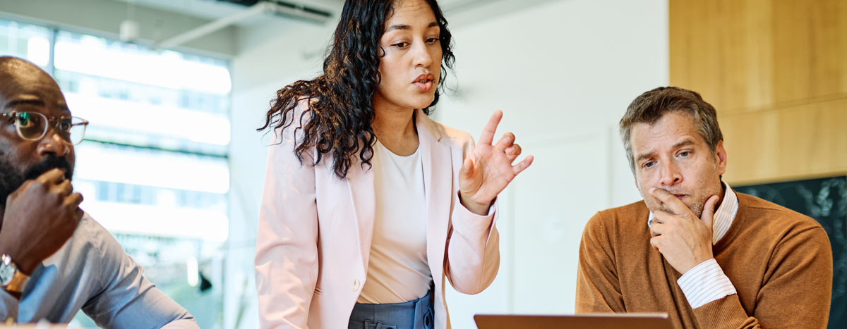 Business meeting with confident leader pointing during a collaborative office teamwork discussion