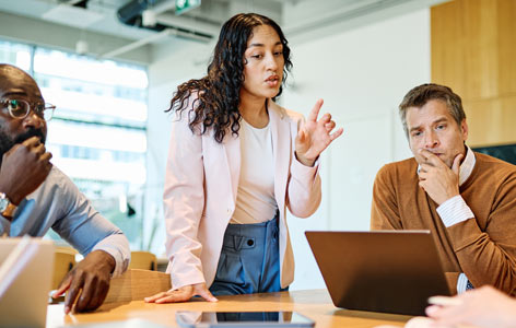 Business meeting with confident leader pointing during a collaborative office teamwork discussion