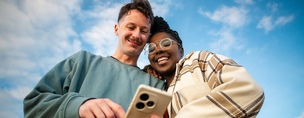 Two people looking at a phone