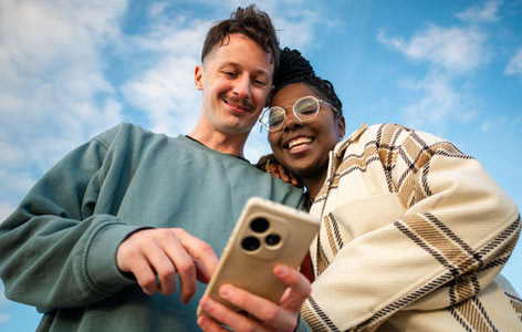 Two people looking at a phone