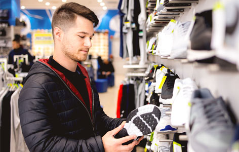 A person holding a shoe in hand